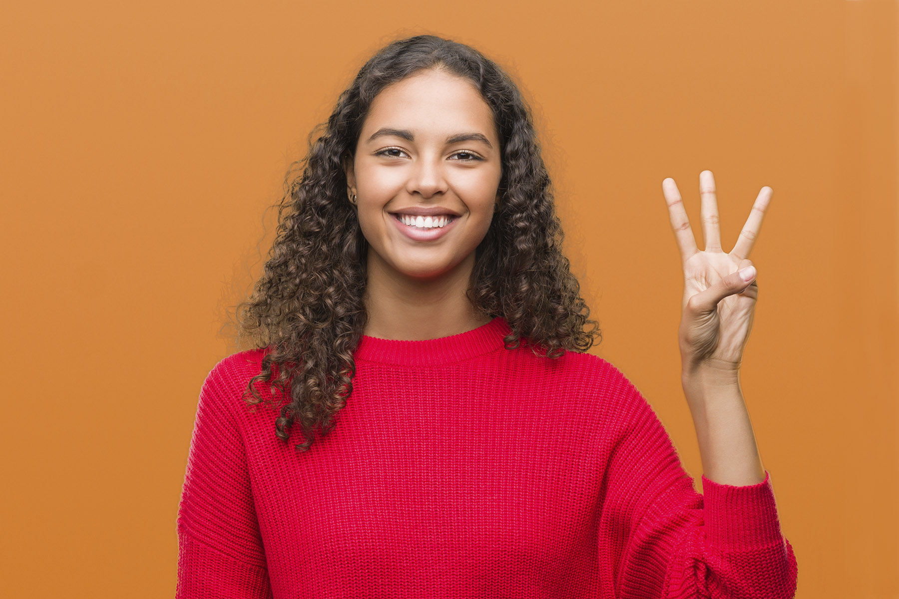 Woman holding up 3 fingers