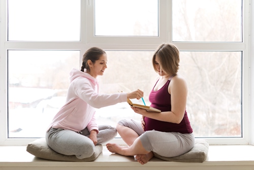 A pregnancy health coach shares valuable information with an expectant mother