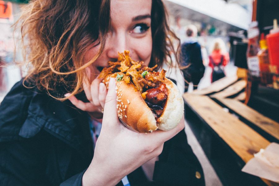 woman eating hotdogs on no diet day